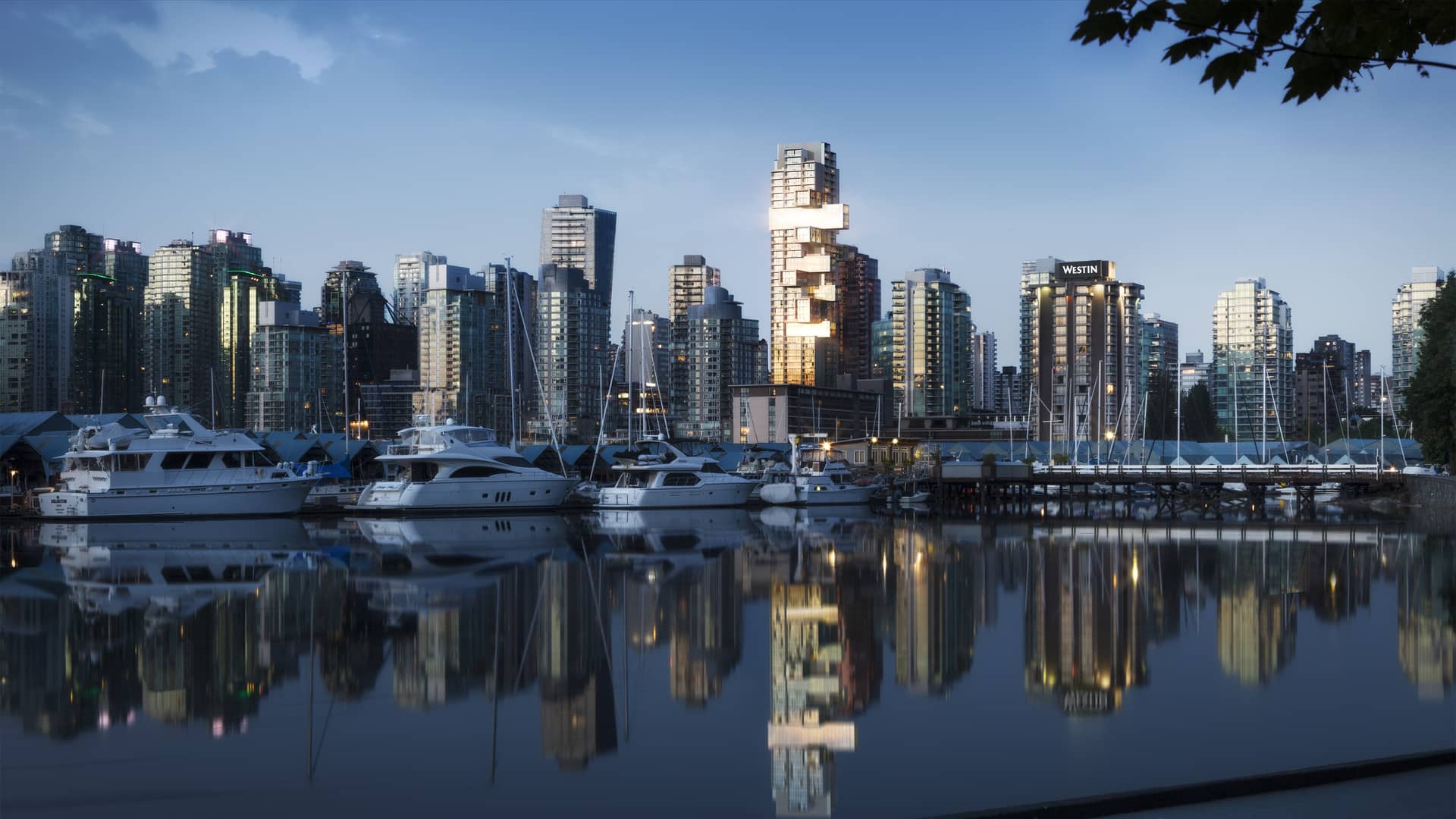 Fifteen Fifteen, an illuminated tower across Coal Harbour at dusk with waterfront reflections